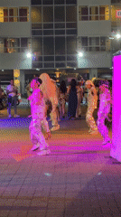 Drag queens perform outdoor dance in silver costumes, Kathu
