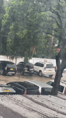 Heavy rain falls across Dar es-Salaam parking lots, streets