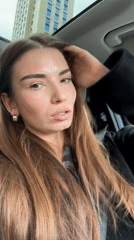 Woman records video message from car driver's seat