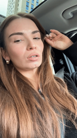 Woman records video message from car driver's seat