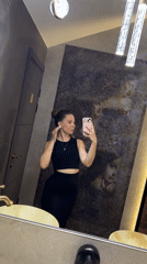 Woman documents restaurant visit with selfies in Klin, Russia