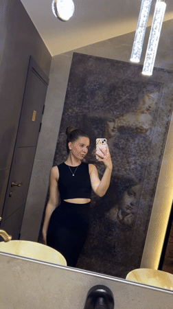 Woman documents restaurant visit with selfies in Klin, Russia