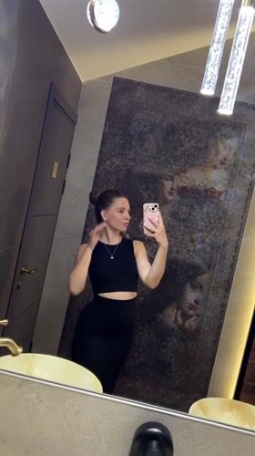 Woman documents restaurant visit with selfies in Klin, Russia