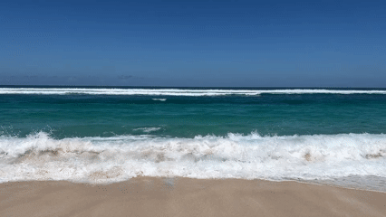 Morning beach activity recorded at Kuta Selatan under sunny skies