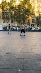 Skateboarder performs aerial tricks in urban plaza