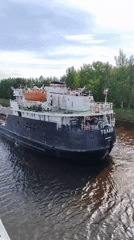 Cargo ships and barges navigate busy waterways in Vytegra