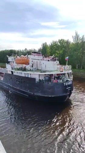 Cargo ships and barges navigate busy waterways in Vytegra