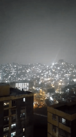 Heavy rain documented in nighttime Caracas cityscape footage