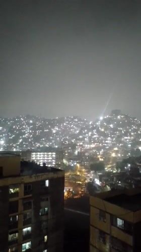 Heavy rain documented in nighttime Caracas cityscape footage