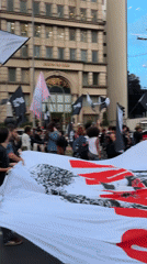 Protesters march through São Paulo streets with banners, signs