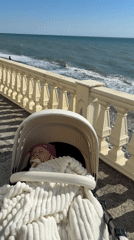 Mother and baby enjoy sunny day at Sochi beach