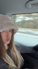 Woman photographed in vehicle traveling through French Alps region