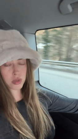 Woman photographed in vehicle traveling through French Alps region