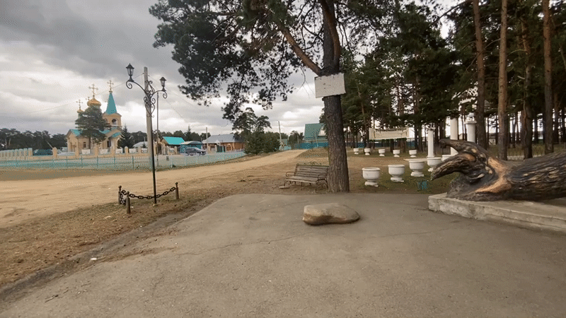 Tourist documents Sosnovka landmarks including bear sculptures, Orthodox church