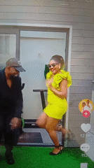 Dancing outside a gym on green turf in Mubi
