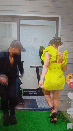 Dancing outside a gym on green turf in Mubi