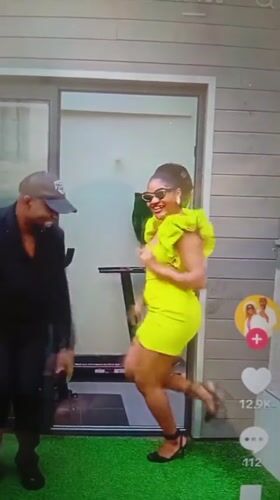 Dancing outside a gym on green turf in Mubi