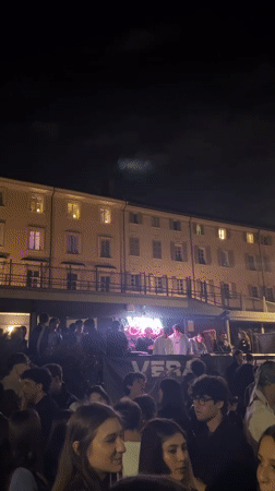 Young adults gather for outdoor night event in Turin