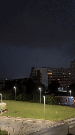 Stormy evening in Belgrade mixing indoor screens and rainy cityscapes