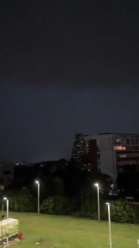 Stormy evening in Belgrade mixing indoor screens and rainy cityscapes