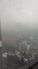 Dense fog blankets Mexico City during evening rainstorm