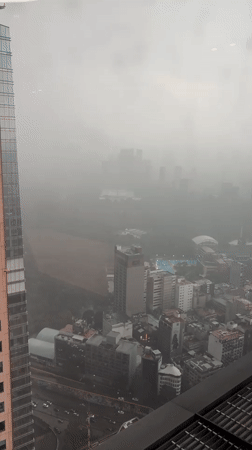 Dense fog blankets Mexico City during evening rainstorm