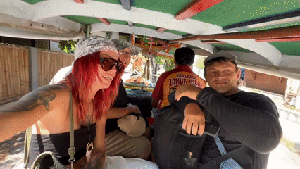 Horse-drawn cart carries tourists through Indonesian city streets