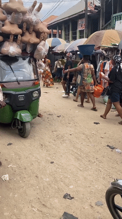 Nigerian market vendors conduct daily business in Umuode, Aba
