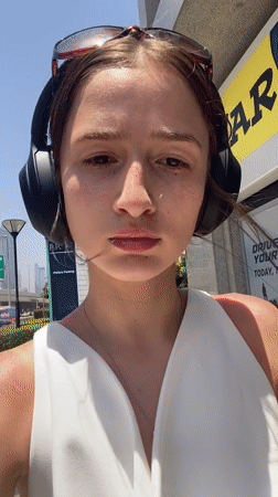 Woman walks Business Bay pedestrian area during sunny morning
