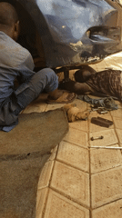 Mechanics repair blue car in Sabon Tasha Nigeria