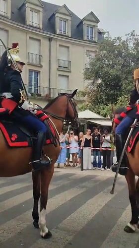 Cavalry riders in full dress uniform parade through Blois
