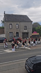 Marching band parade proceeds through Belgian village streets