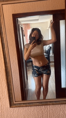 Woman takes mirror selfies in Podgorica home, cat meows