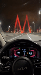 Driver crosses illuminated bridge in Kazan at night