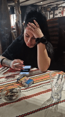 Woman smoking, using phone at Plovdiv restaurant