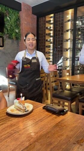 Restaurant staff perform tambourine celebration in Villa El Salvador