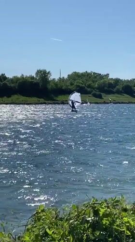 Windsurfer enjoys sunny afternoon on Vienna lake