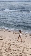 Two women walk beach during morning in Kuta Selatan