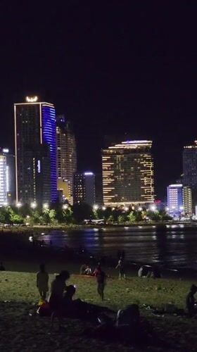 Illuminated Nha Trang coastline captured in nighttime observations