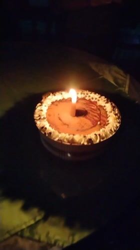 Nighttime outdoor dining celebration with cake in Tinaquillo, Venezuela