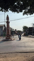 Street-level look at Kebonsari's monuments, shops, and aging buildings