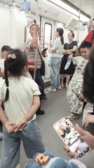 Children dance on moving subway car in Shapingba District