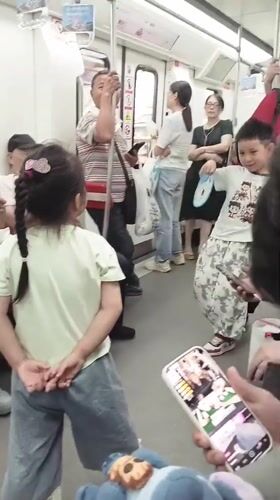 Children dance on moving subway car in Shapingba District