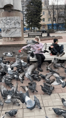 Children feed pigeon flock in Ulyanovsk park