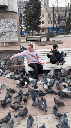 Children feed pigeon flock in Ulyanovsk park