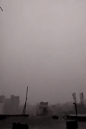 Heavy rain and fog shroud Dhaka cityscape