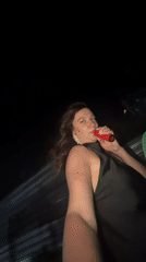Woman films selfie video while riding in vehicle at night