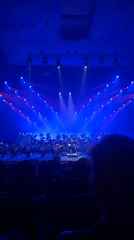 Live orchestra performs under colorful stage lights in Yerevan