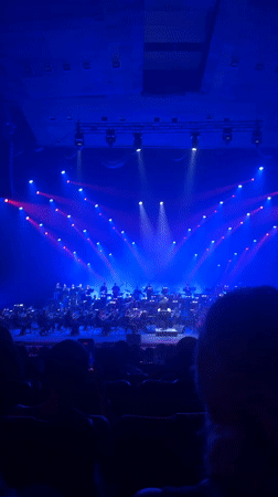 Live orchestra performs under colorful stage lights in Yerevan
