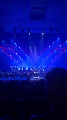 Live orchestra performs under colorful stage lights in Yerevan